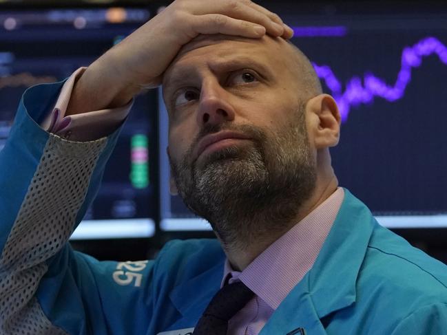 (FILES) In this file photo taken on March 9, 2020 Meric Greenbaum, Designated Market Maker IMC financial looks up at the board before the opening bell right before trading halted on the New York Stock Exchange on in New York. - Wall Street stocks finished another rocky session much lower on March 23, 2020 amid partisan squabbling over a giant stimulus package as the Federal Reserve announced new emergency measures. (Photo by TIMOTHY A. CLARY / AFP)