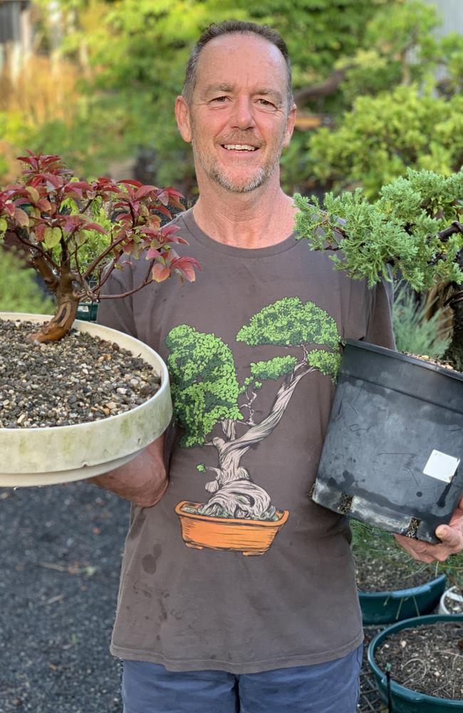 Avid bonsai enthusiast Michael Watt has about 100 bonsai. He is holding a Pacific crabapple in his right hand and a 15-year-old juniper tree in his left. He has spent hours crafting these trees. He’s had some of these for 15 years old. Picture: Janessa Ekert