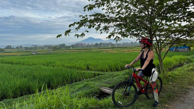 Cycling through rice paddies near Tabanan, Bali.