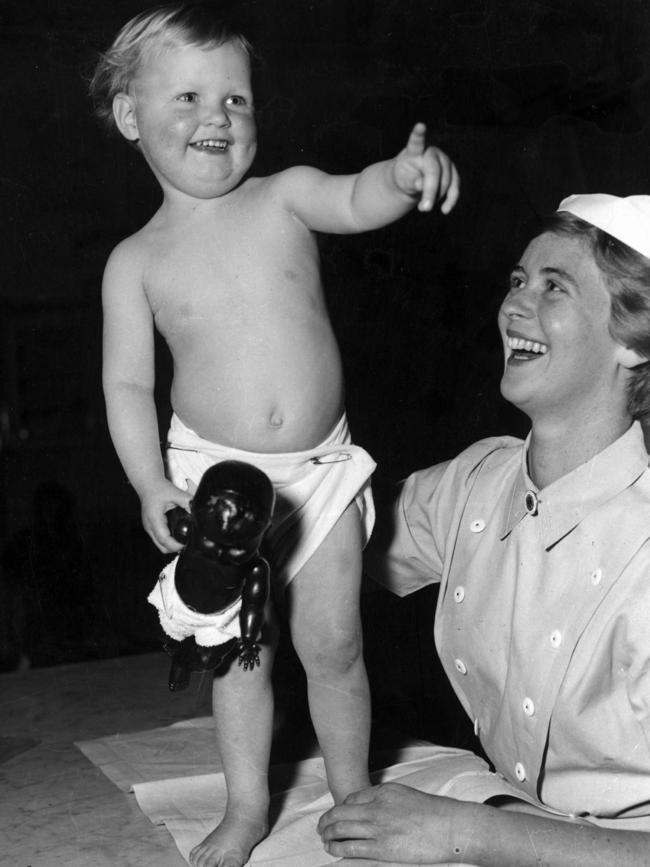 A nurse having fun with a patient in 1959.