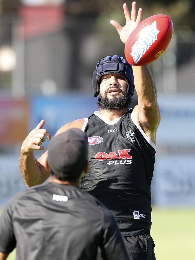 Paddy Ryder tries out a helmet at training on Tuesday. Picture Sarah Reed