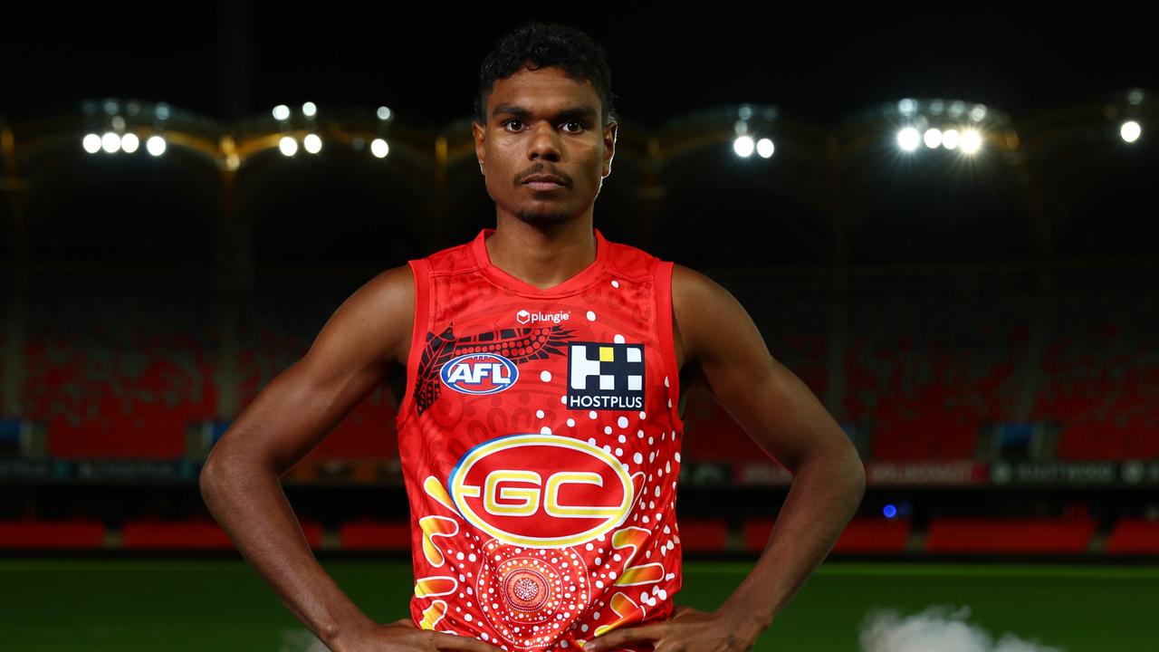 Lloyd Johnston of the Suns poses with the Gold Coast Suns AFL Indigenous Guernsey at Heritage Bank Stadium. Picture: Chris Hyde/Getty Images