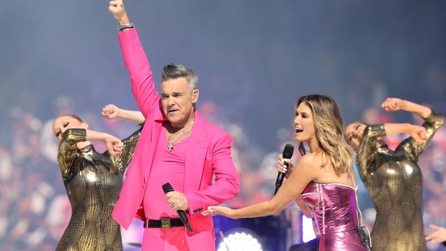 Robbie Williams and Delta Goodrem performing for the packed MCG. Picture: David Caird