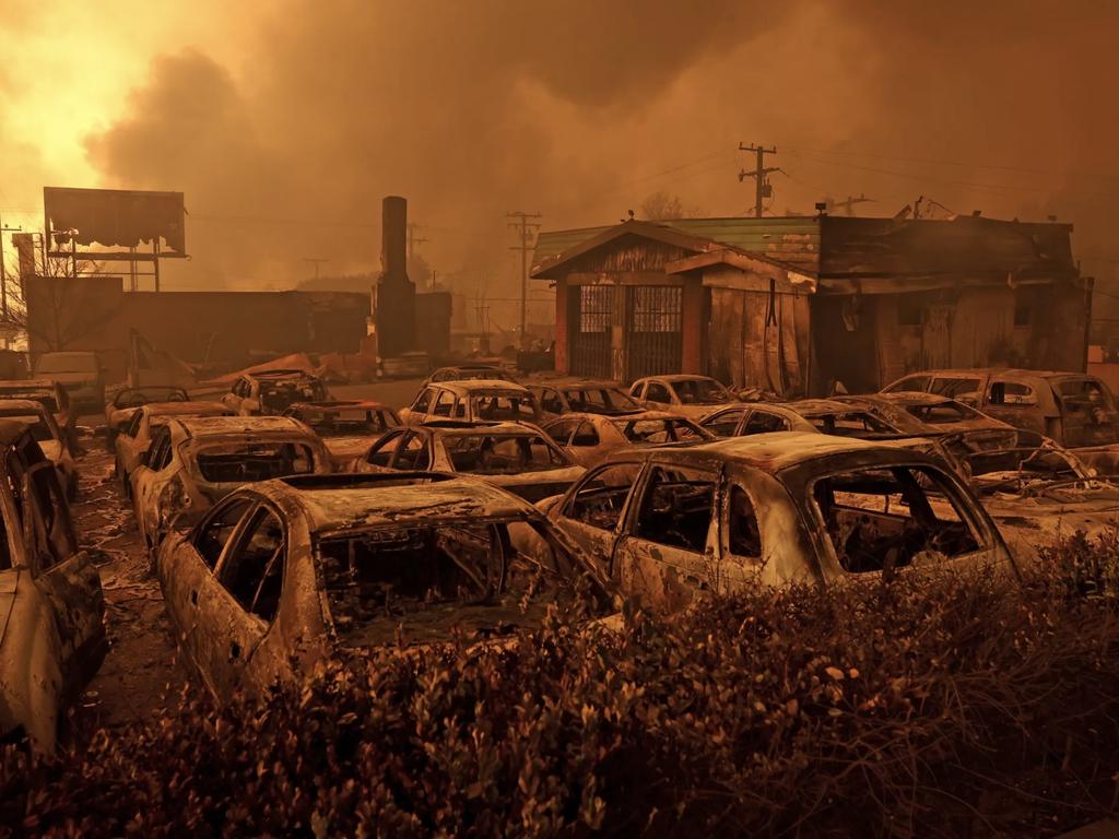 AFTER: Cars destroyed by the Eaton Fire sit in the parking area of a burned auto shop in Altadena on January 8. Picture: Getty Images