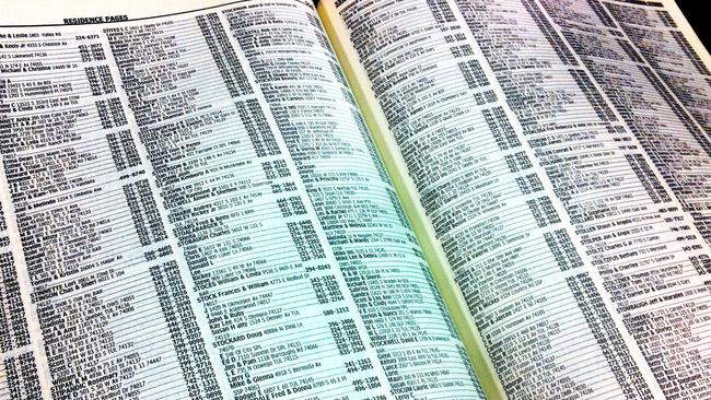 Open page of white pages telephone directory book.