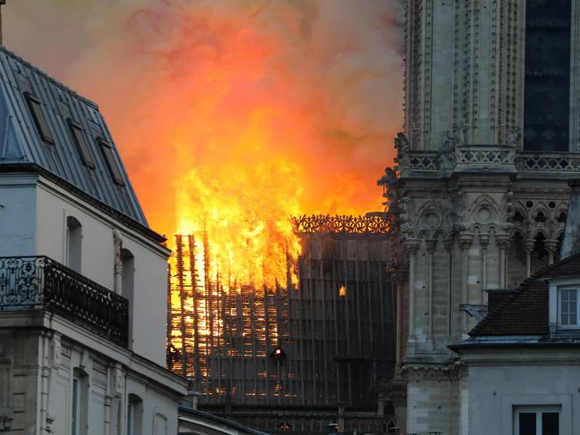 Smoke and flames rise during a fire at the landmark Notre-Dame Cathedral in central Paris on April 15, 2019, potentially involving renovation works being carried out at the site, the fire service said. - A major fire broke out at the landmark Notre-Dame Cathedral in central Paris sending flames and huge clouds of grey smoke billowing into the sky, the fire service said. The flames and smoke plumed from the spire and roof of the gothic cathedral, visited by millions of people a year, where renovations are currently underway. (Photo by LUDOVIC MARIN / AFP)