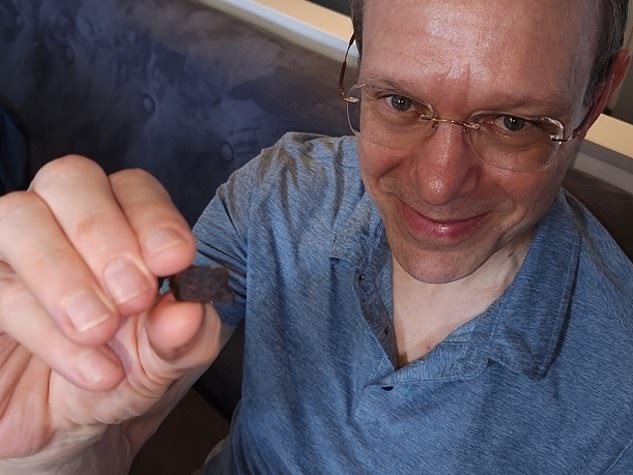 Professor Loeb with a non-spherical piece of iron recovered during the mission. Picture: Avi Loeb / Medium.