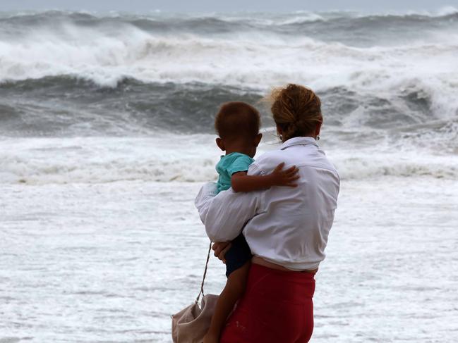 GOLD COAST, AUSTRALIA - NewsWire Photos MARCH 6, 2025: Members of the public on Main Beach where record high 12 metre waves were recorded on the Gold Coast ahead of the expected arrival of Cyclone Alfred. Picture: NewsWire/Tertius Pickard