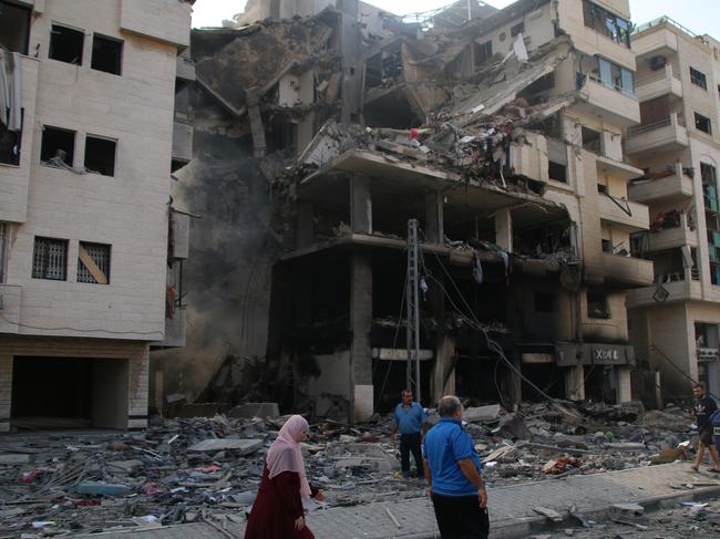 GAZA CITY, GAZA - OCTOBER 10: Palestinian citizens inspect damage to their homes caused by Israeli airstrikes on October 10, 2023 in Gaza City, Gaza. Almost 500 people have died in Gaza after Israel launched sustained retaliatory air strikes after Saturday's attack by Hamas. (Photo by Ahmad Hasaballah/Getty Images)