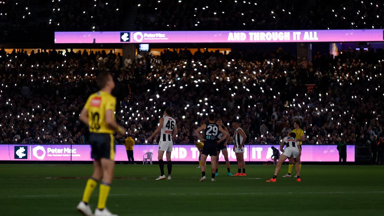 MELBOURNE, AUSTRALIA - MAY 03: The MCG lights up to the tune of Angels by Robbie Williams, honouring all those who are currently battling cancer, and those who have lost their fight before the 2024 AFL Round 08 match between the Carlton Blues and the Collingwood Magpies at The Melbourne Cricket Ground on May 03, 2024 in Melbourne, Australia. (Photo by Michael Willson/AFL Photos via Getty Images)