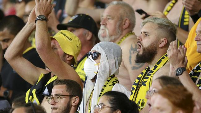 A fan wears a mask during match between Wellington Phoenix and Melbourne Victory in Wellington.