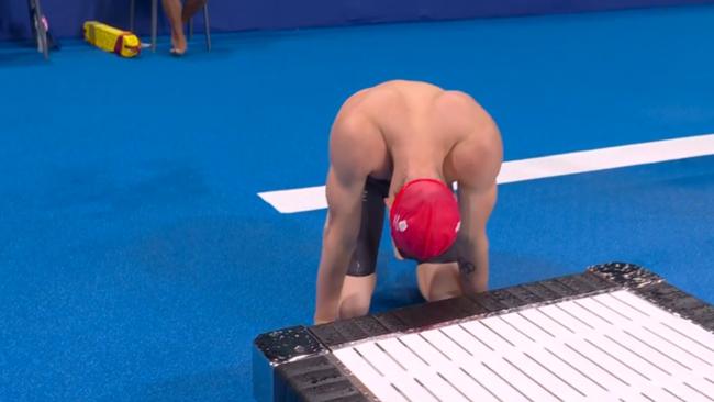 The swimmer collapsed to the pool deck.