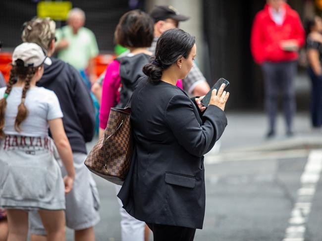 SYDNEY, AUSTRALIA - NewsWire Photos February 06, 2024:  A generic photograph of people on their phone in Sydney.Picture: NCA NewsWire / Christian Gilles