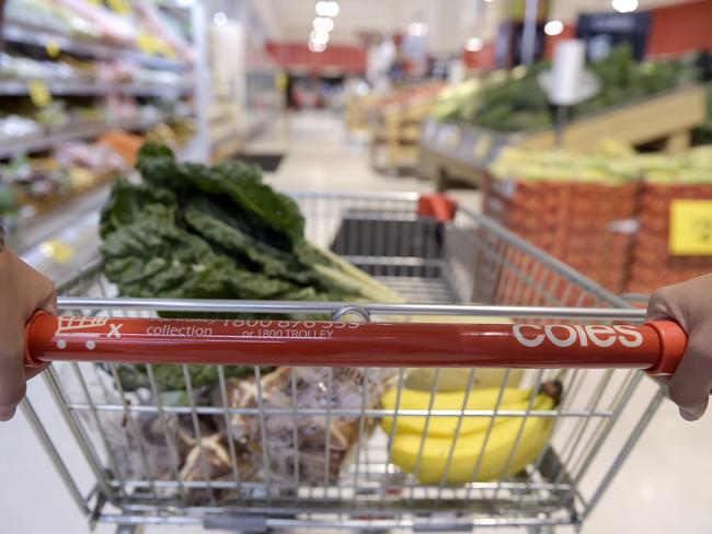 A customer pushes a shopping cart down an aisle at a Coles supermarket, operated by Wesfarmers Ltd., in the Richmond area of Melbourne, Australia, on Friday, Feb. 10, 2017. Wesfarmers, Australia's largest retailer, is scheduled to report fourth-quarter results on Feb. 15. Photographer: Carla Gottgens/Bloomberg