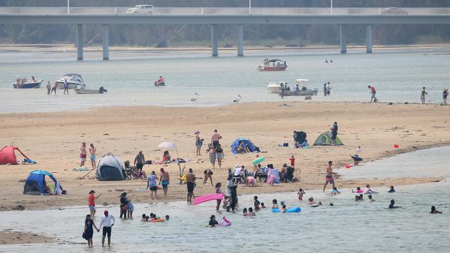 The Entrance holiday crowd pictured in January 2020. The Entrance SLSC has had to call on volunteers from other surf clubs to deal with the influx of crowds at the dangerous channel at the time. Picture: Sue Graham