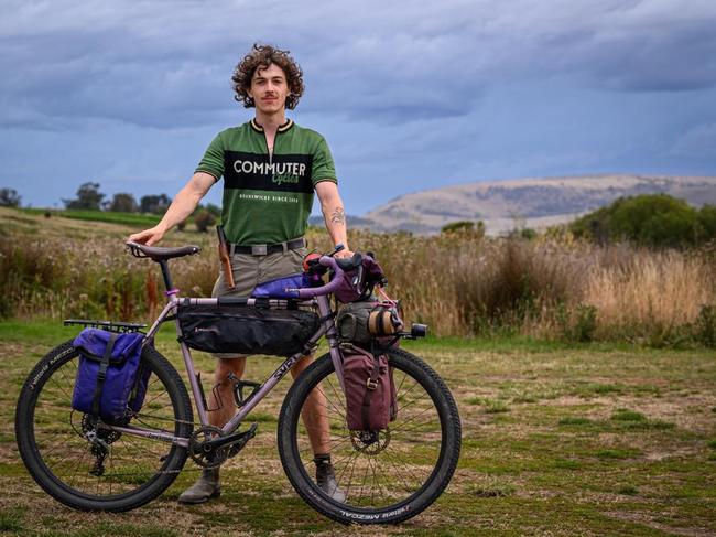 Finn Mollison, 22, is a student studying environmental and social sciences at the University of Melbourne. He aspires to be a writer and befriended columnist Charles Wooley while he was on a cycling tour of tassie and was in the Highlands lakes area. Picture: Supplied.