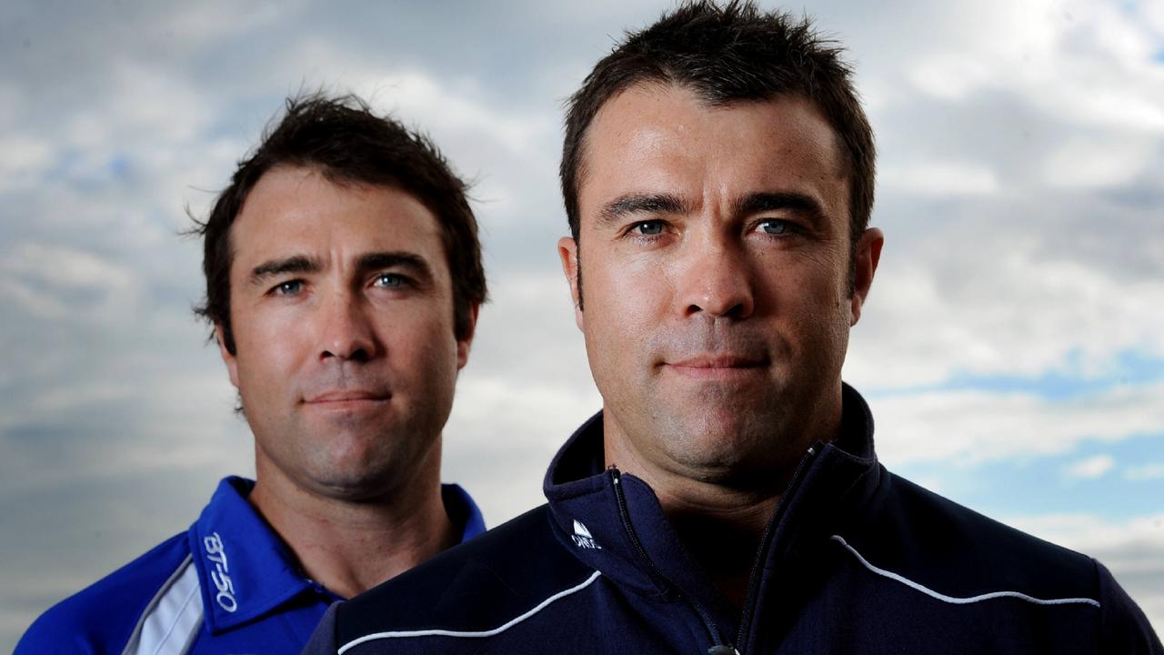 Then-Kangaroos’ coach Brad Scott and twin brother, Geelong coach Chris Scott, before they faced each other for the first time as opposing coaches.