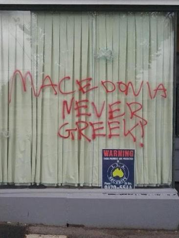 Graffiti Bullet holes in the window of offices used by the Pan Macedonian Association of Melbourne and Victoria with the phrase “Macedonia never Greek!”