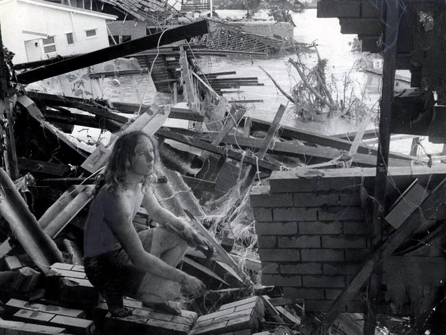 The Esplanade Yeronga - Rod Balmer in what was the lounge of his house. In the b/g are other devastated houses. Pic George Lipman