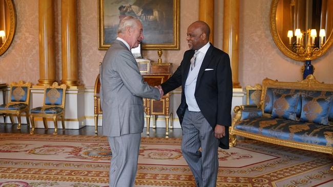 Britain's King Charles III, left, shakes hands with Alexander Williams, the High Commissioner of Jamaica, during an audience at Buckingham Palace. Picture: AFP