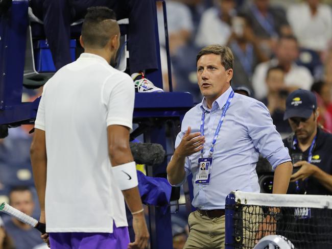 Nick Kyrgios discusses a ruling with tournament official Remy Azemar. (Photo by Elsa/Getty Images)