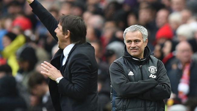 Manchester United's Portuguese manager Jose Mourinho (R) looks on as Chelsea's Italian head coach Antonio Conte (L) gestures.