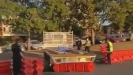 A man has been fined $4000 and charged with multiple offences after growing frustrated trying to re-enter Queensland and running through the border barricades. Picture: 9 News