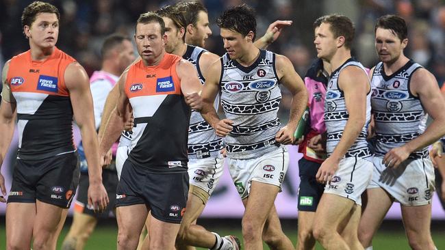 Steve Johnson and Andrew Mackie exchange words after Joel Selwood’s final term goal. AAP Image/Julian Smith.