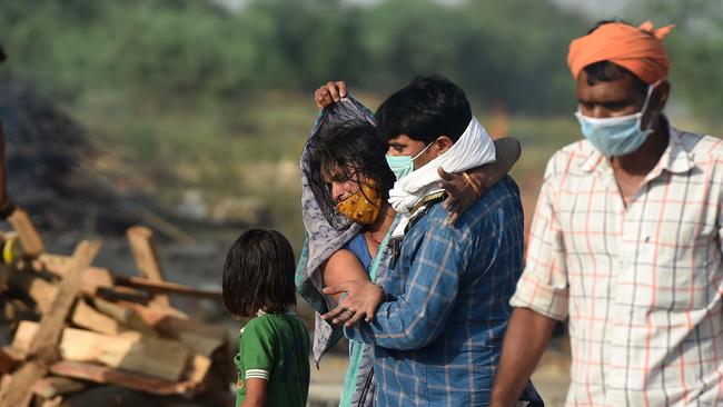 Relatives mourn during the cremation of a loved one in India’s Allahabad on Tuesday. Picture: AFP