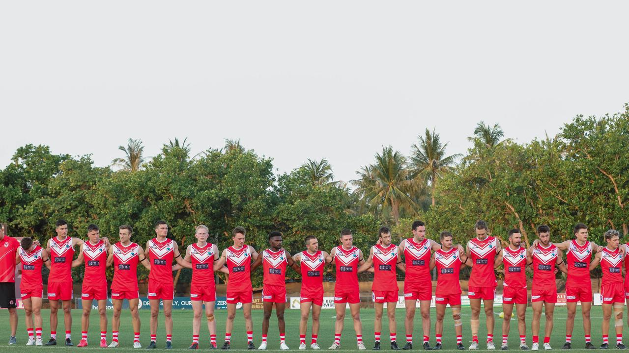 Waratahs observe a 30 second silence to commemorate the life of lost mate Alexander Aurrichio as history made at Gardens Oval with the first game under lights as Waratahs V Palmerston. Picture GLENN CAMPBELL