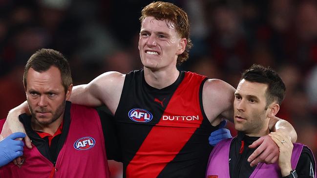 MELBOURNE, AUSTRALIA - MAY 10: Lewis Hayes of the Bombers reacts to an injury during the round nine AFL match between Essendon Bombers and Sydney Swans at Marvel Stadium, on May 10, 2025, in Melbourne, Australia. (Photo by Morgan Hancock/Getty Images)
