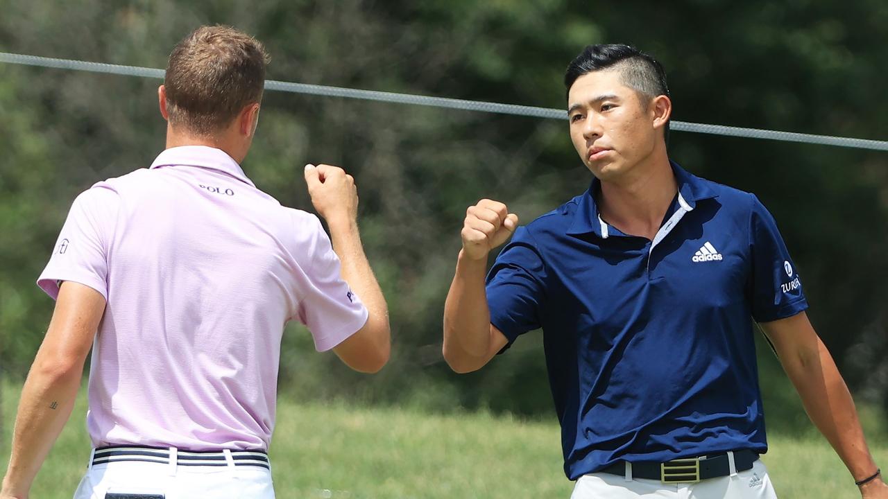 Collin Morikawa is congratulated by Justin Thomas after the playoff win.