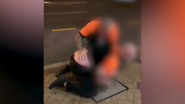 Security guards have been filmed slapping a man outside a Brisbane hotel.