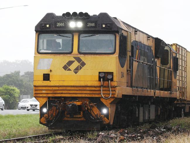 An Aurizon freight train loaded with cargo heads south along the railway tracks at Woree, south of Cairns. PICTURE: BRENDAN RADKE