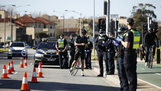 Police check licenses of cyclists along St Kilda Beach in Melbourne. Picture: Daniel Pockett