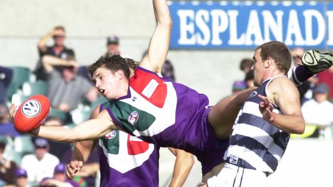 Justin Longmuir climbs above Steven King during his playing days with the Dockers.