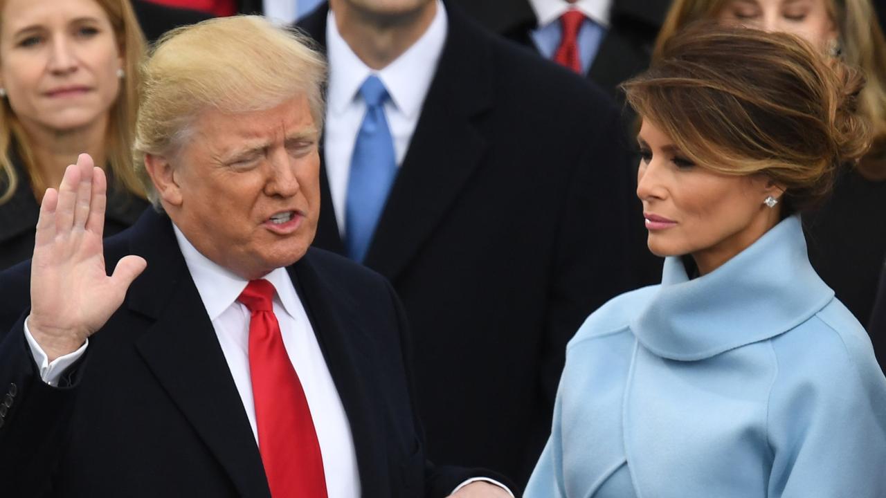 Mr Trump, pictured with wife Melania at his 2017 inauguration, is reportedly “yearning” to get back to Washington. Picture: Mark Ralston/AFP