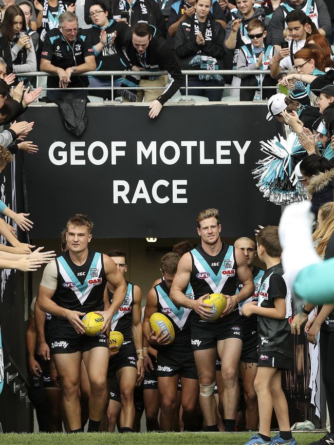 Dual captains Ollie Wines and Tom Jonas lead Port Adelaide out on to the ground. Picture SARAH REED