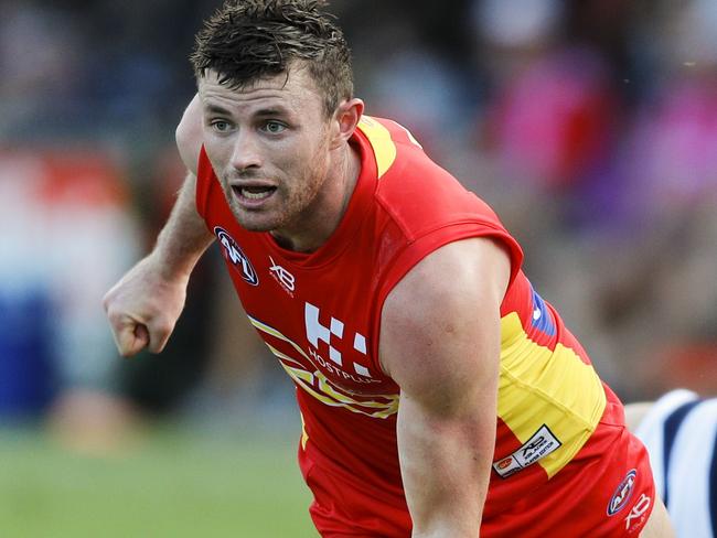 Pearce Hanley of Gold Coast Suns passes the ball during the AFL JLT Community Series match between the Gold Coast Suns and the Geelong Cats at Riverway Stadium in Townsville, Sunday, March 4, 2018. (AAP Image/Dave Acree) NO ARCHIVING, EDITORIAL USE ONLY