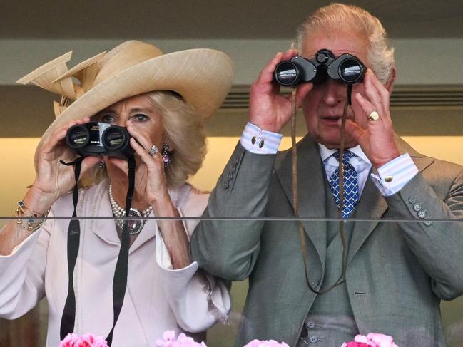 Britain's Queen Camilla (L) and Britain's King Charles III (R) watch the races with their binoculars on the second day of the Royal Ascot horse racing meeting, in Ascot, west of London, on June 21, 2023. (Photo by JUSTIN TALLIS / AFP)