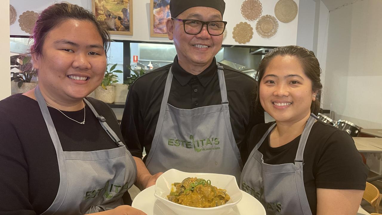 Hannah Gavina, chef Ted Ileto and Evajane Veracion with the kare-kare (peanut stew) at Estelita's Filipino Kusina at Parramatta.