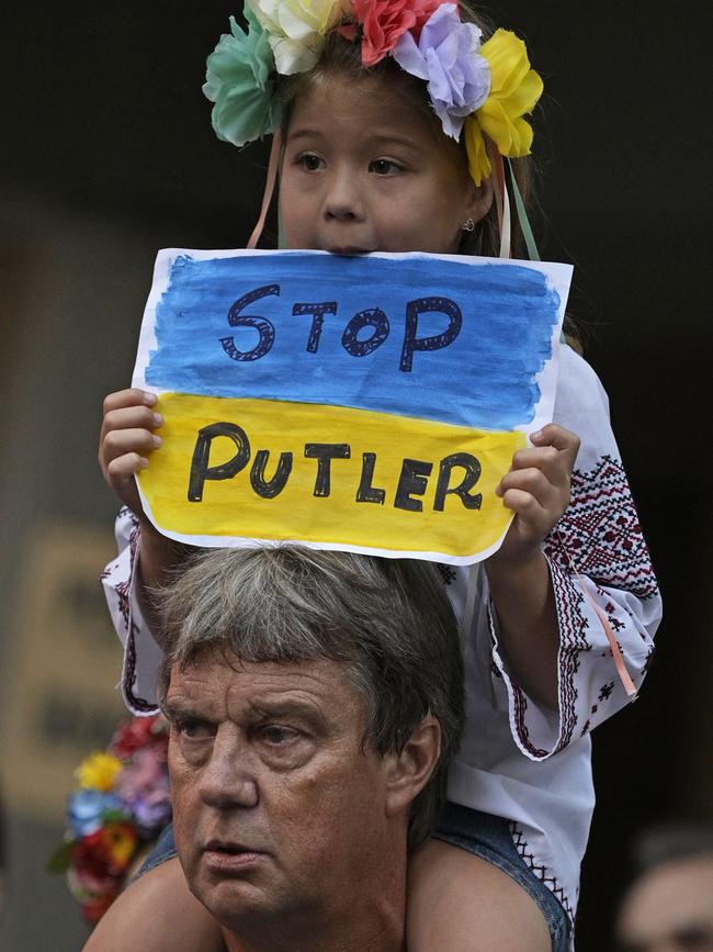 A Ukranian girl holds a sign reading "Stop Putler" during a protest outside of the Russian embassy in Buenos Aires, on March 1, 2022. Picture: JUAN MABROMATA / AFP