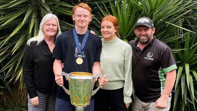 Emerging Demon Jake Bowey poses alongside his family with the AFL premiership cup. Picture: Instagram