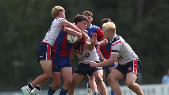 Cody Baker held up by the Roosters’ defence. Picture: Sue Graham