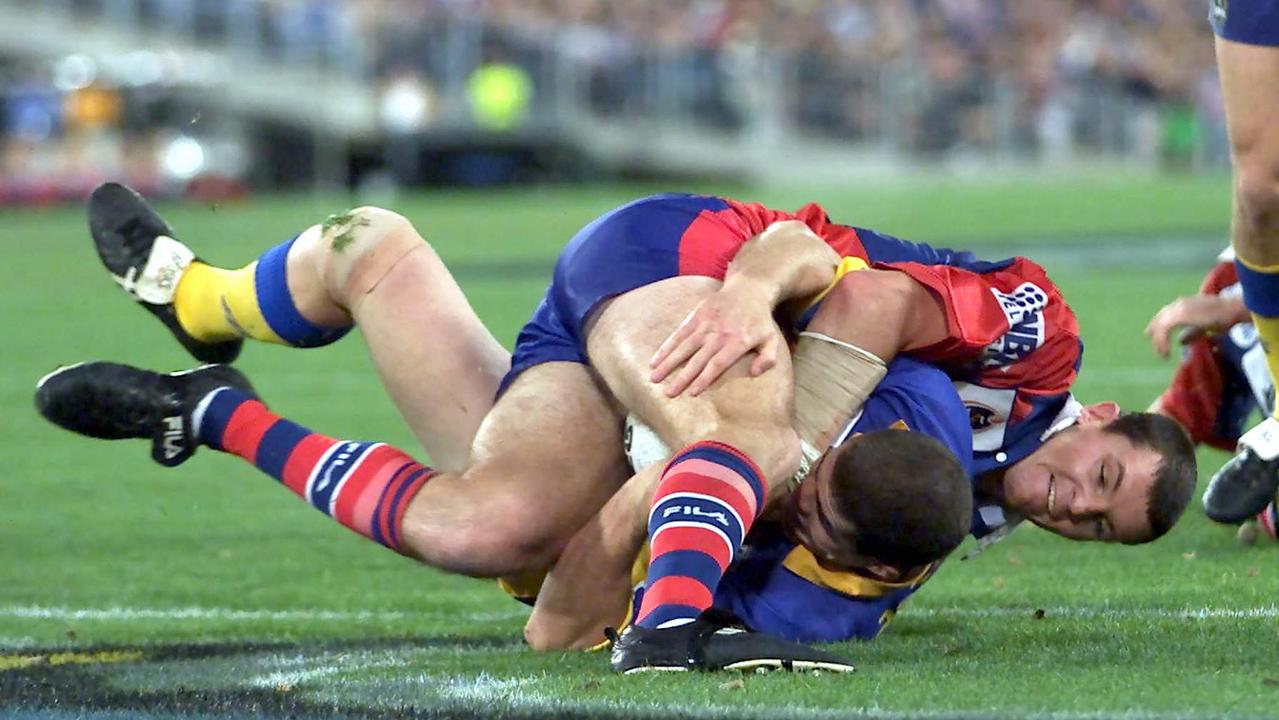 Steve Simpson (top) pulls off a ‘miracle’ trysaver to prevent Andrew Ryan. Picture: Brett Faulkner