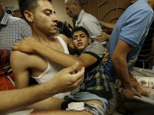 A Palestinian man, injured in an Israeli air strike at a market place in the Shejaiya neighbourhood, arrives to be treated at a hospital in Gaza City. Picture: Mohammed Abed