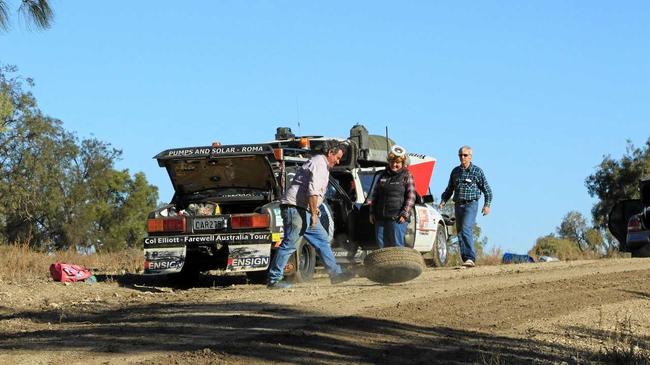 OFF-ROAD RALLY: Michael (left) and Juanita work to repair a flat tire during the start of their journey.