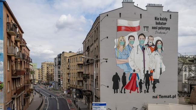 A mural paying tribute to the sacrifice of doctors, nurses and paramedics fighting with epidemic of the new coronavirus COVID-19, is seen in Warsaw, Poland. Picture: AFP