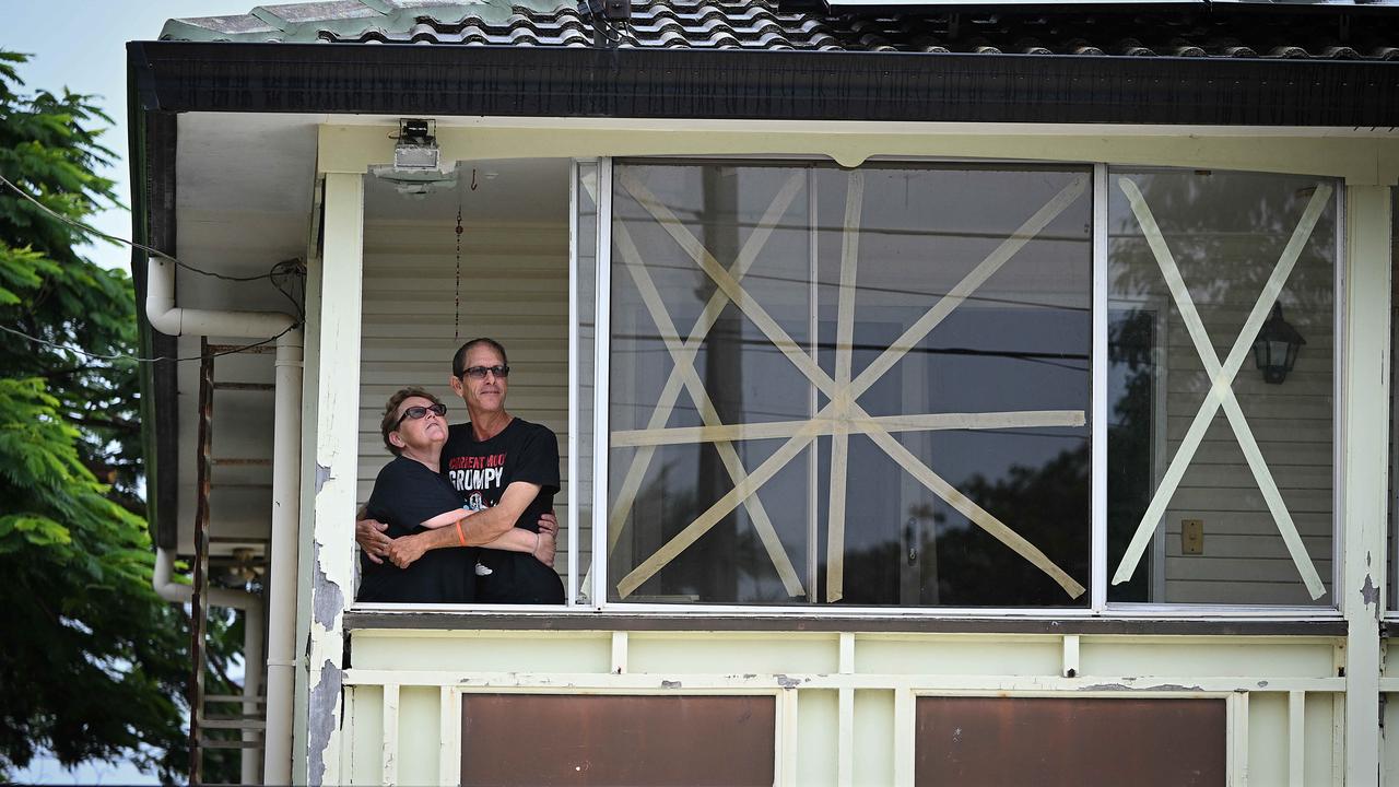 Cindy and Shane Hyde take a short break from preparations ahead of the arrival of cyclone Alfred at their home in near Birkdale. Picture: Lyndon Mechielsen/Courier Mail