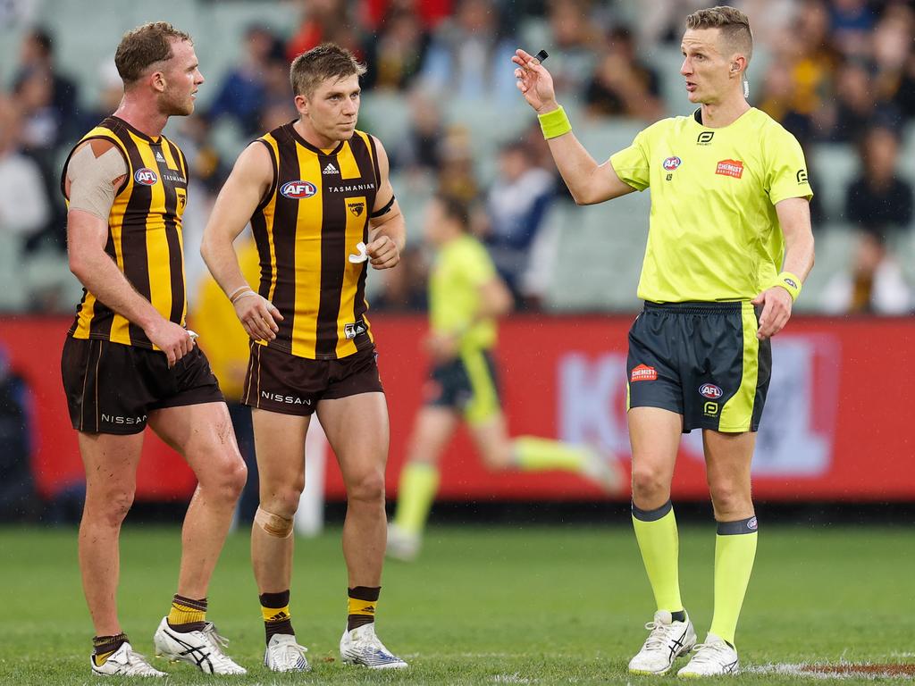 Tom Mitchell of the Hawks speaks with AFL field umpire Hayden Gavine after a 50m penalty was awarded to Geelong during a round 5 match at the MCG. Picture: Michael Willson/AFL Photos via Getty Images
